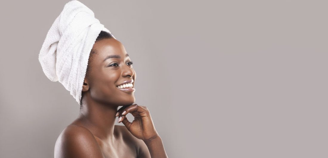 Image of woman in with a towel wrapped around her body and a towel on her head