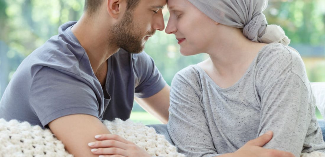 Image of woman with cancer cuddling man