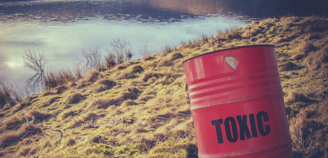 Image of toxic waste barrel near water