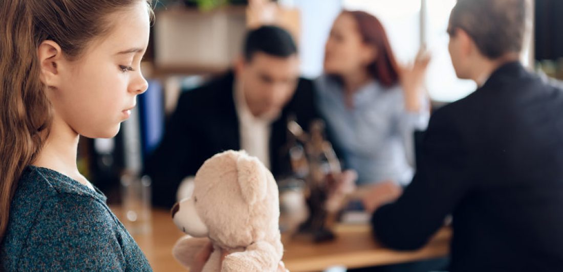 Image of arguing couple with a child holding a stuffed bear