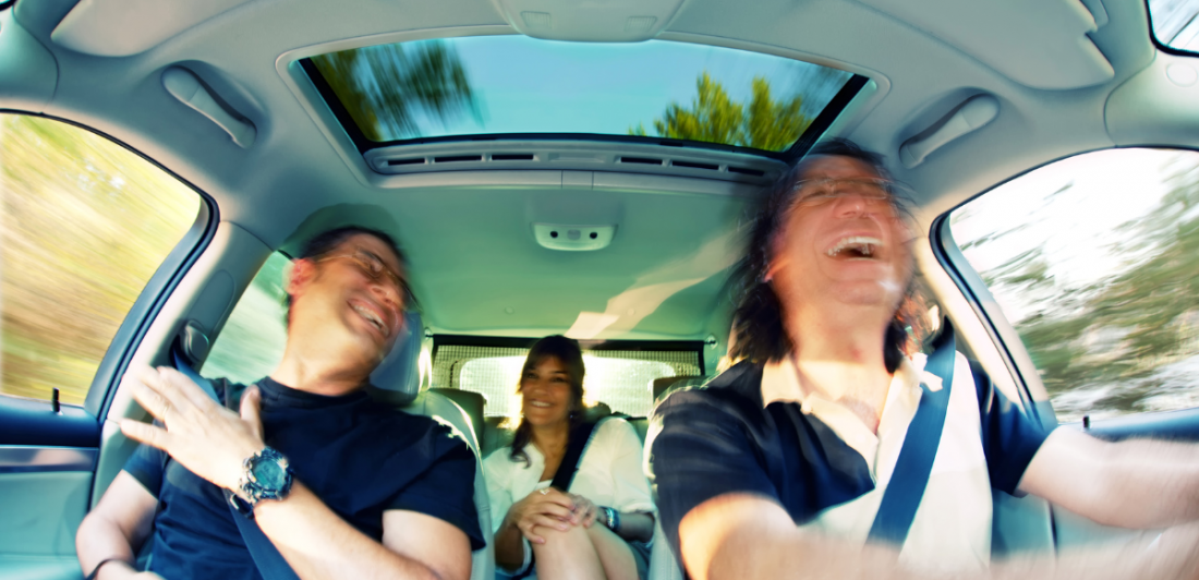 Image of happy people inside a vehicle