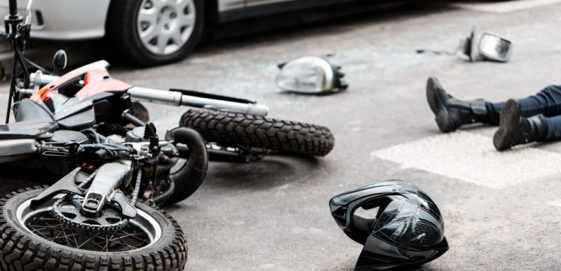 Image of crashed motorcycle with injured driver