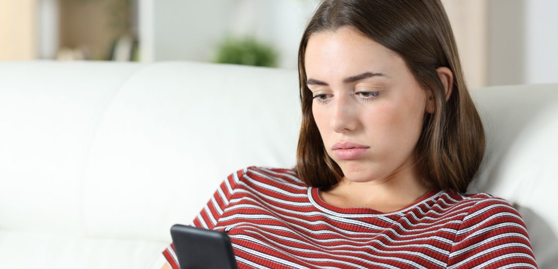 Image of teen looking at her cell phone