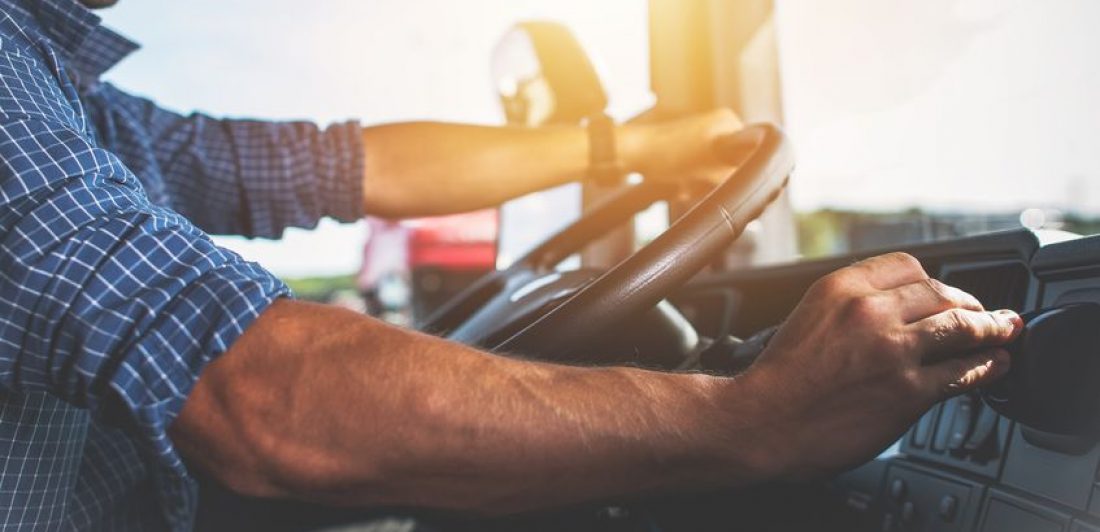 Image of man driving a semi truck