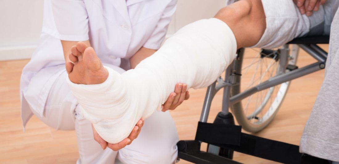 Image of medical professional and injured person in a leg cast