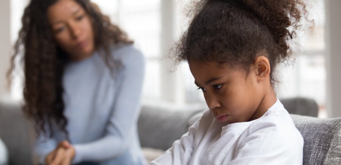 Woman talking to upset girl