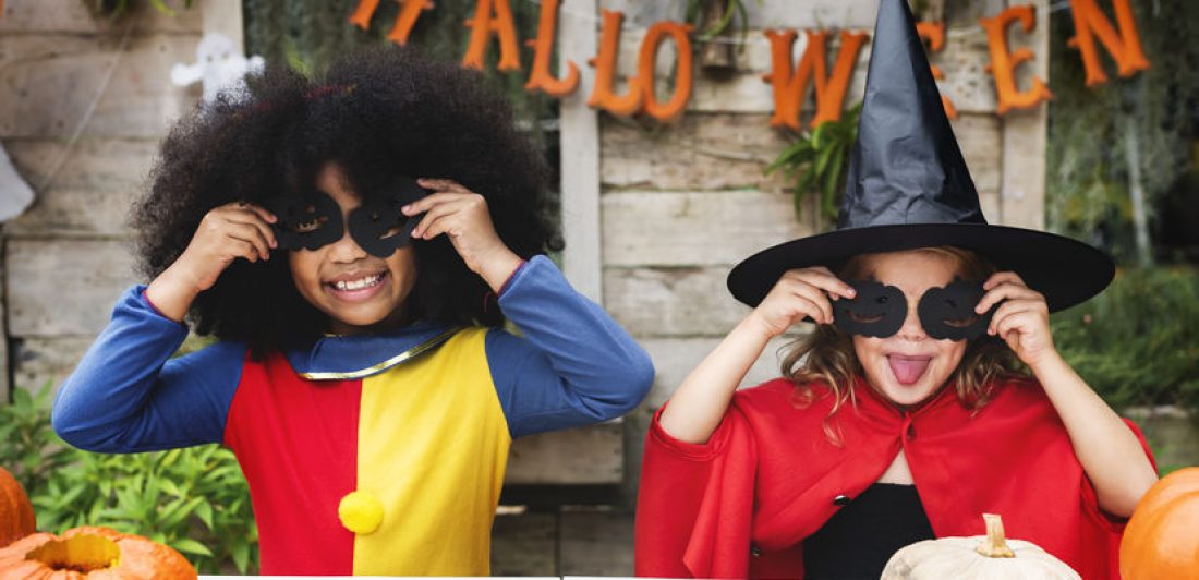 Image of children dressed up as a clown and a witch on halloween