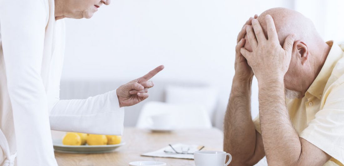 Image of elderly woman waving her finger at elderly man who has his head in his hands