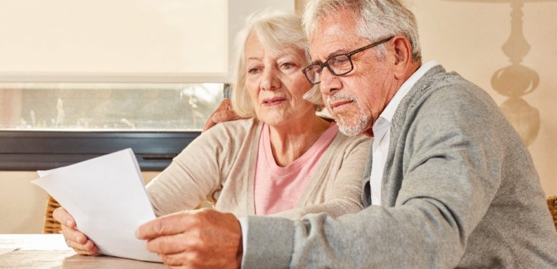 Image of elderly couple reading paperwork