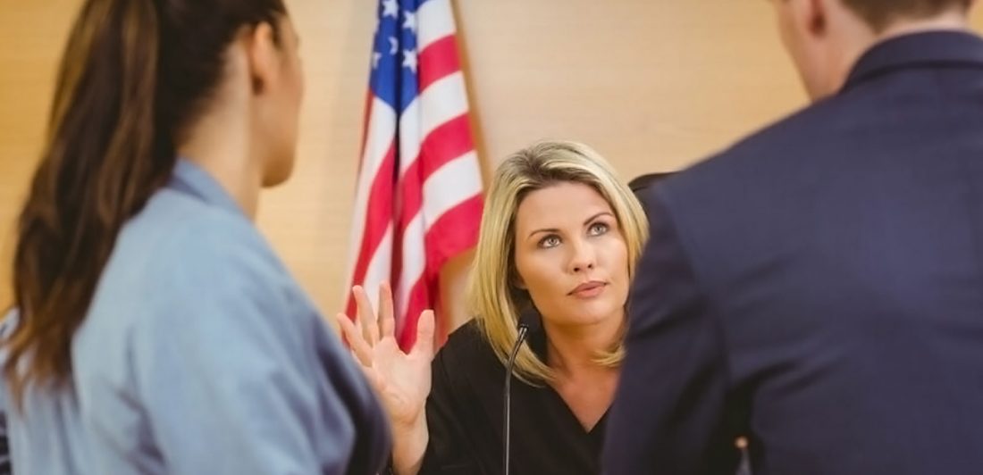 Graphic of a man and woman speaking to a judge in front of an american flag