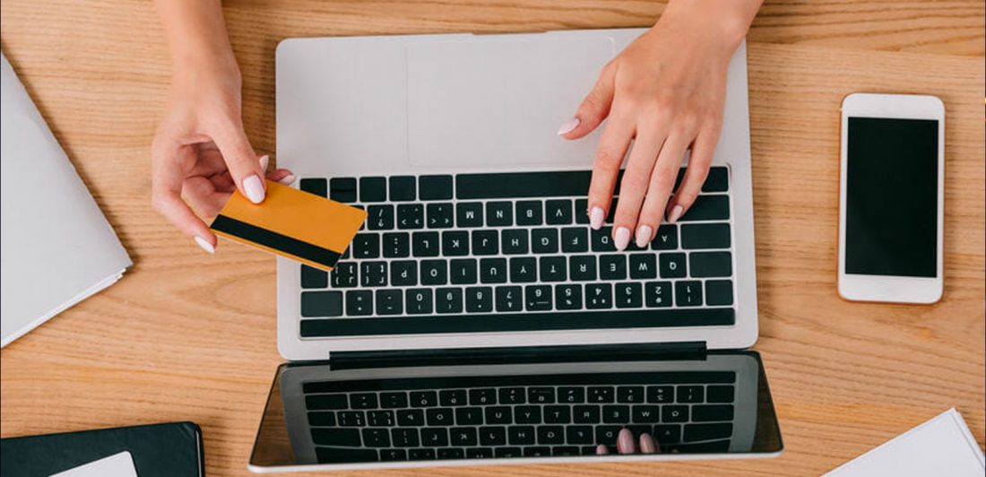 Image of a woman making an online payment on a laptop