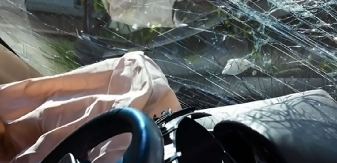 Image of a deployed airbag and broken windshield