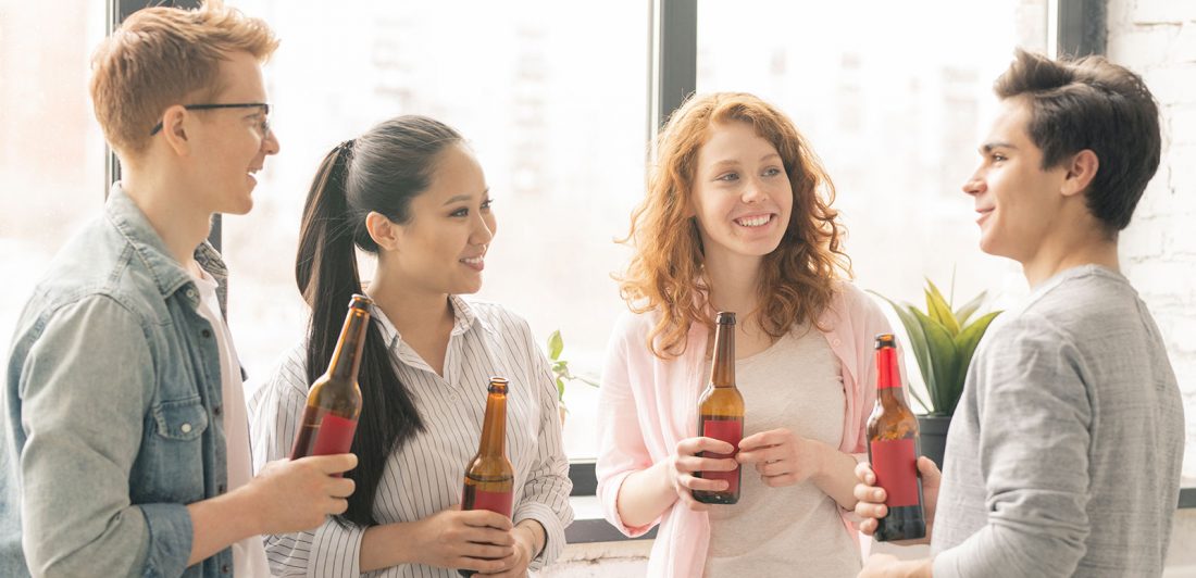 Image of college students drinking bottles of beer