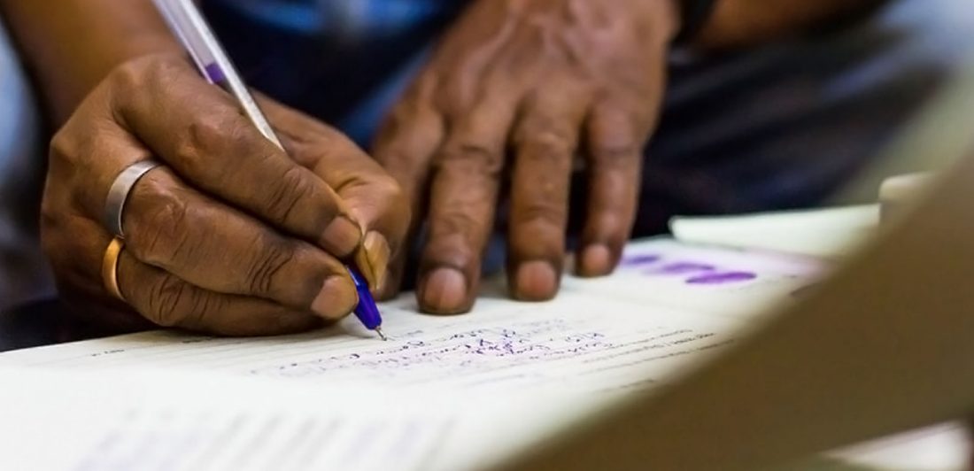 Image of person filling out paperwork