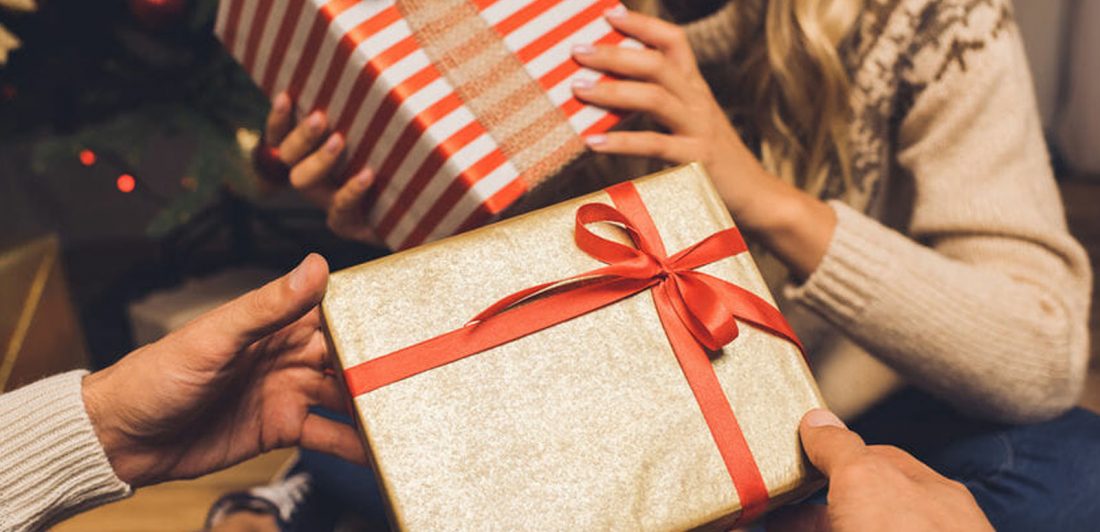 Image of two people exchanging gifts