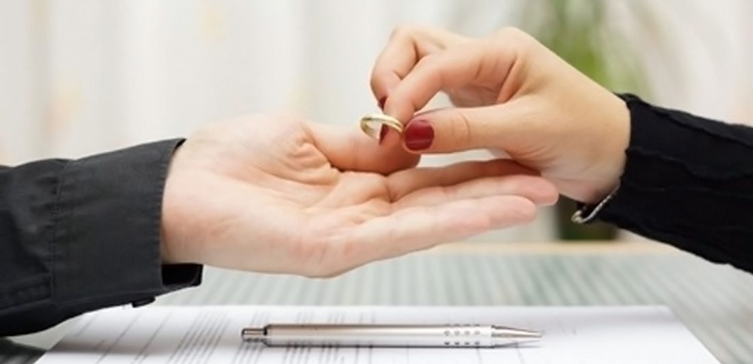 Image of a woman handing her wedding ring to a man