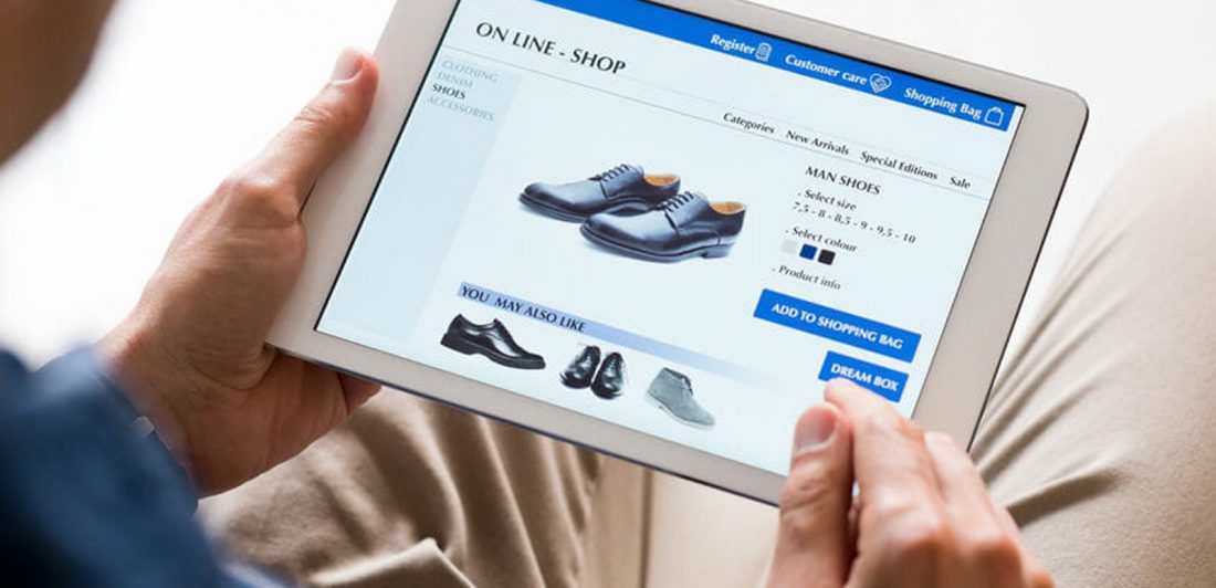 Image of man shopping online for black dress shoes