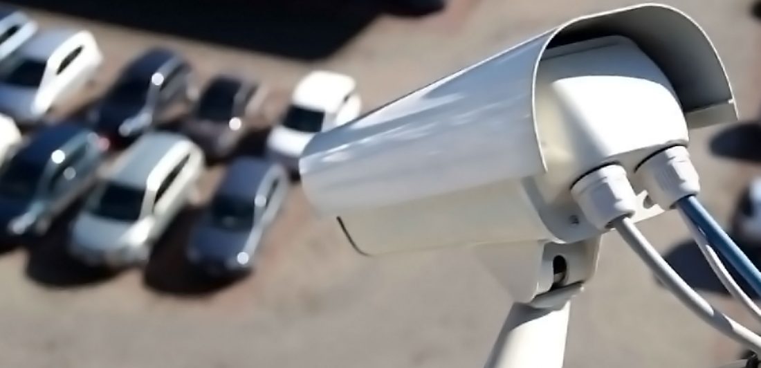 Image of security camera overlooking parking lot filled with cars