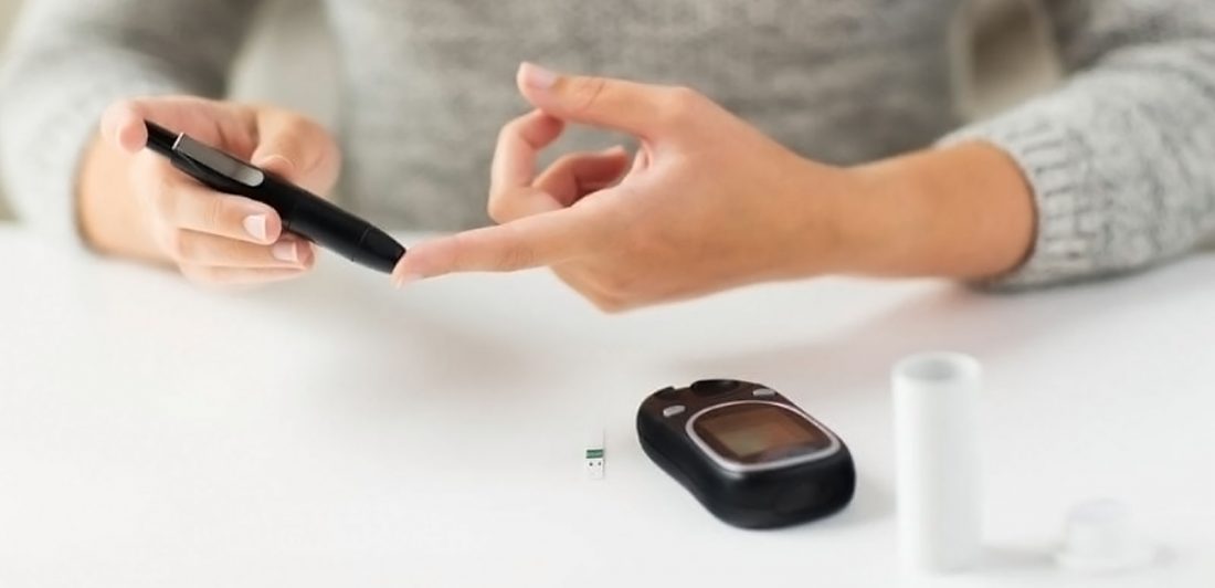 Image of woman testing her blood sugar