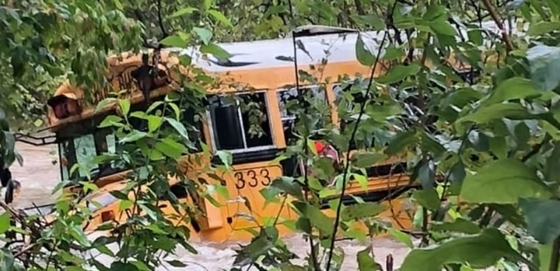 Image of LISD bus being carried away by fast moving water