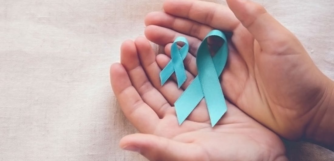 Image of hands holding teal ovarian cancer awareness ribbons