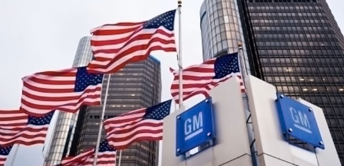 Image of GM building with American flags waving outside