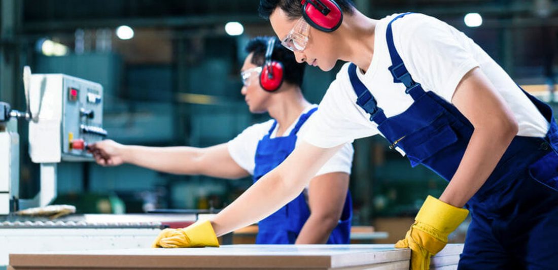 Image of workers in a factory wearing protective gear