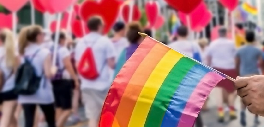 Image of a pride flag and hearts at a pride parade