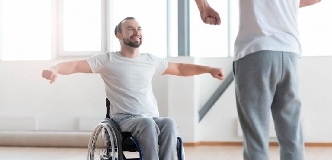 Image of man in a wheelchair performing physical therapy motions