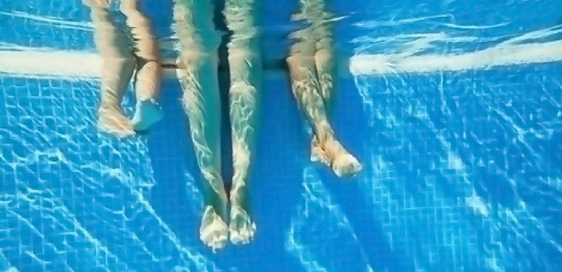 Underwater image of legs in a pool