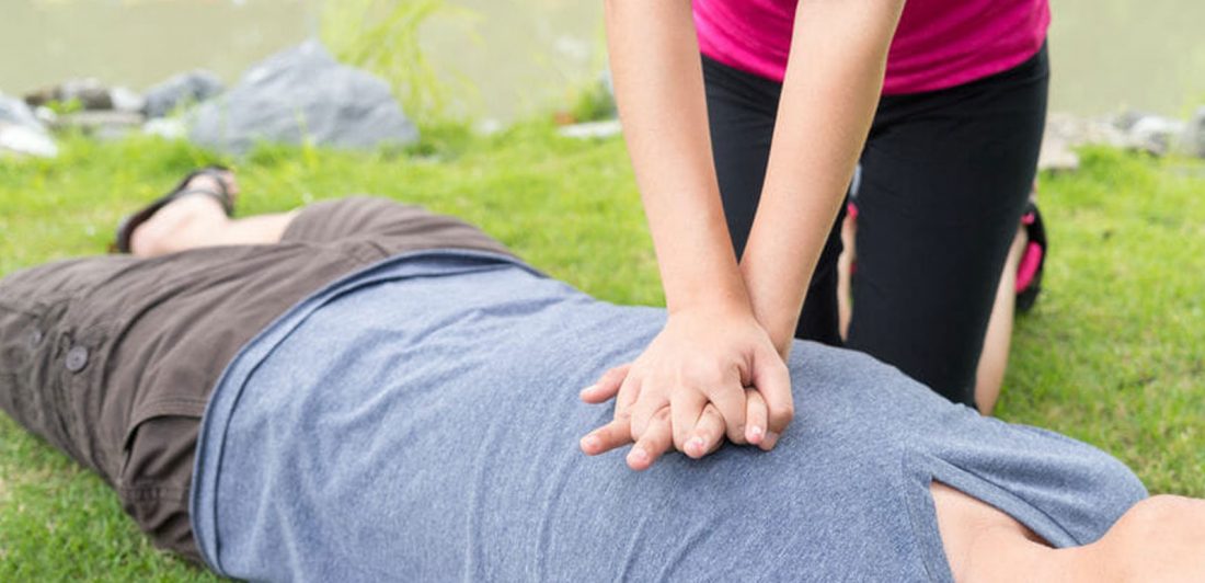 Woman performing CPR on man