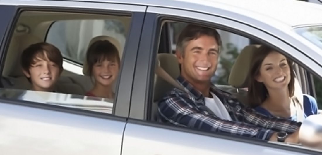 Image of happy family inside a vehicle