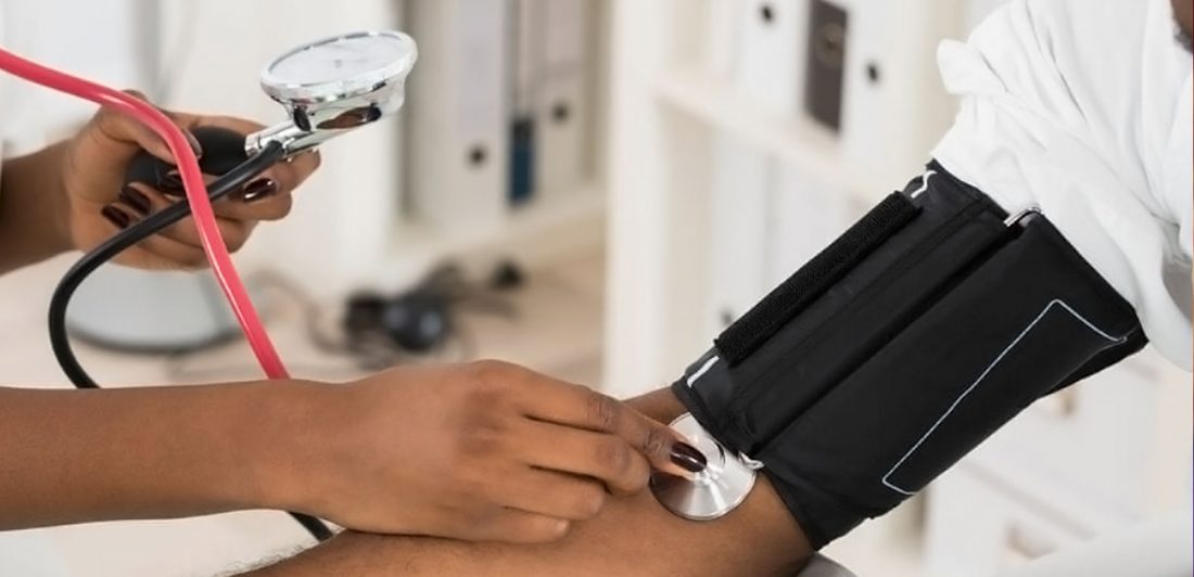 Image of medical professional taking a patient's blood pressure