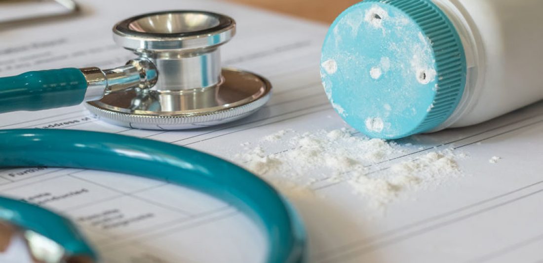 Image of stethoscope, paperwork, and talc powder spilling on table