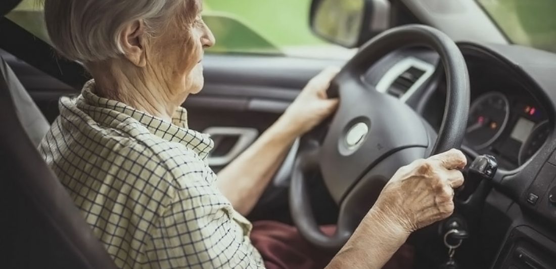 Image of an elderly woman driving a car