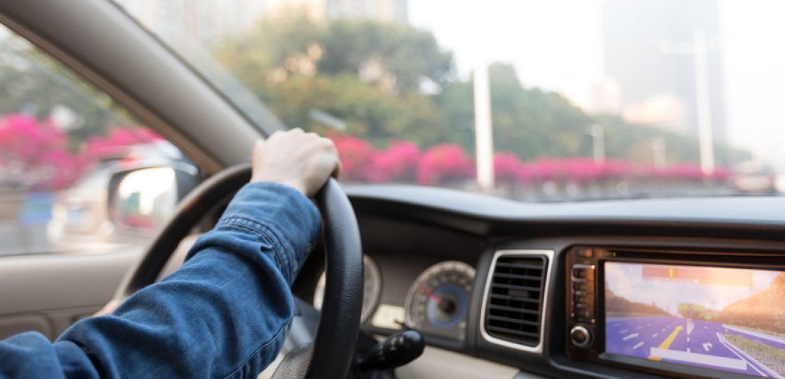 Image of a person behind the wheel of a car