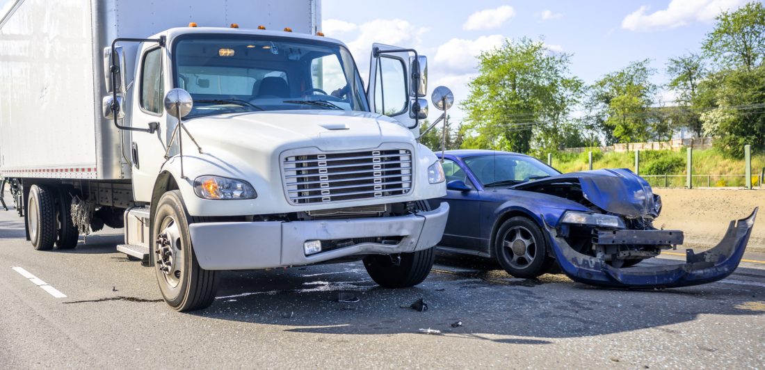 Image of box truck and small car in a collision